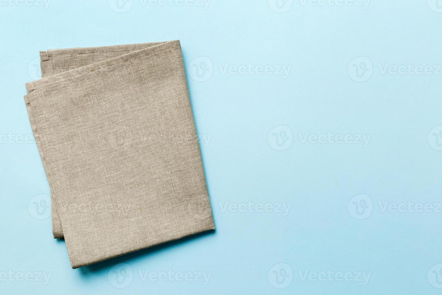 top view with gray kitchen napkin isolated on table background. Folded cloth for mockup with copy space, photo