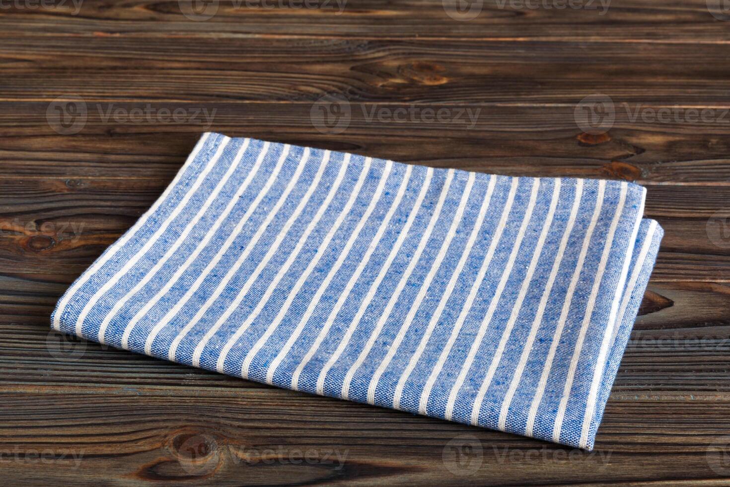 top view with blue kitchen napkin isolated on table. Folded cloth for mockup photo