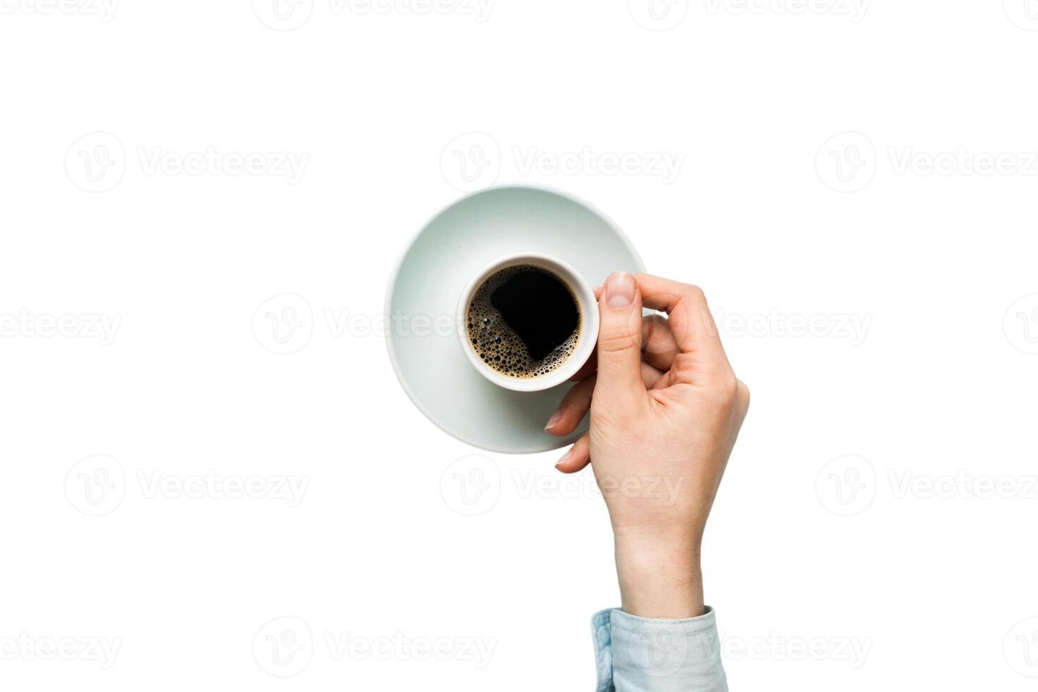 Minimalistic style woman hand holding cup of coffee on Colored background. Flat lay, top view cappuccino cup. Empty place for text, copy space. Coffee addiction. Top view, flat lay photo