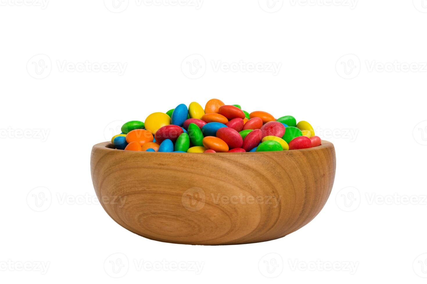 Multicolored candies in a bowl on colored background. birthday and holiday concept. Top view with copy space photo