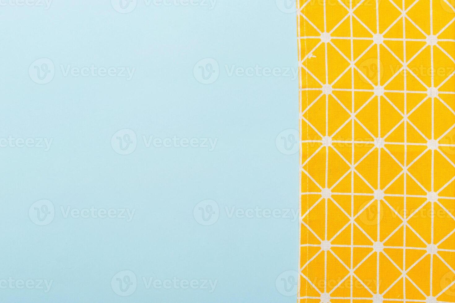 top view with yellow empty kitchen napkin isolated on table. Folded cloth for mockup with copy space, photo