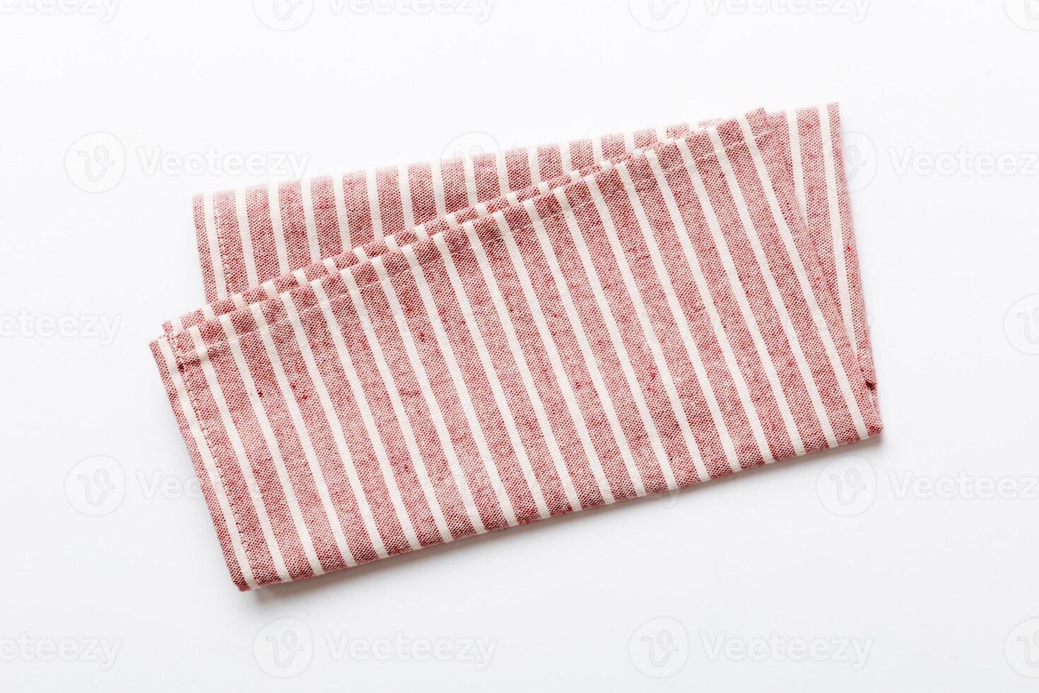 top view red kitchen napkin isolated on table background. Folded cloth for mockup with copy space photo