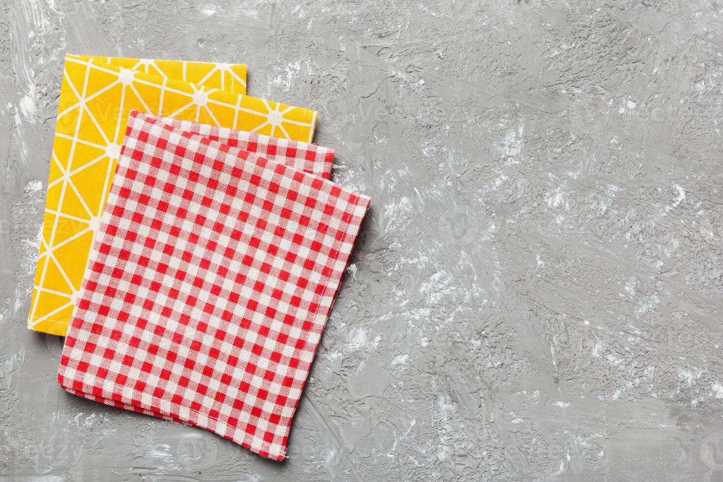 top view with red empty kitchen napkin isolated on table background. Folded cloth mockup with copy space, photo