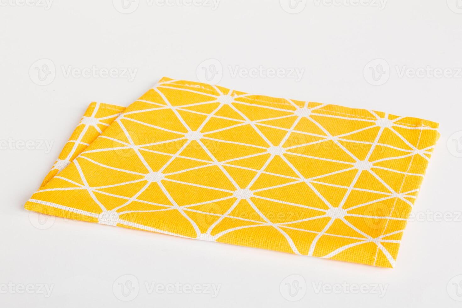 top view with yellow empty kitchen napkin isolated on table background. Folded cloth for mockup with copy space photo