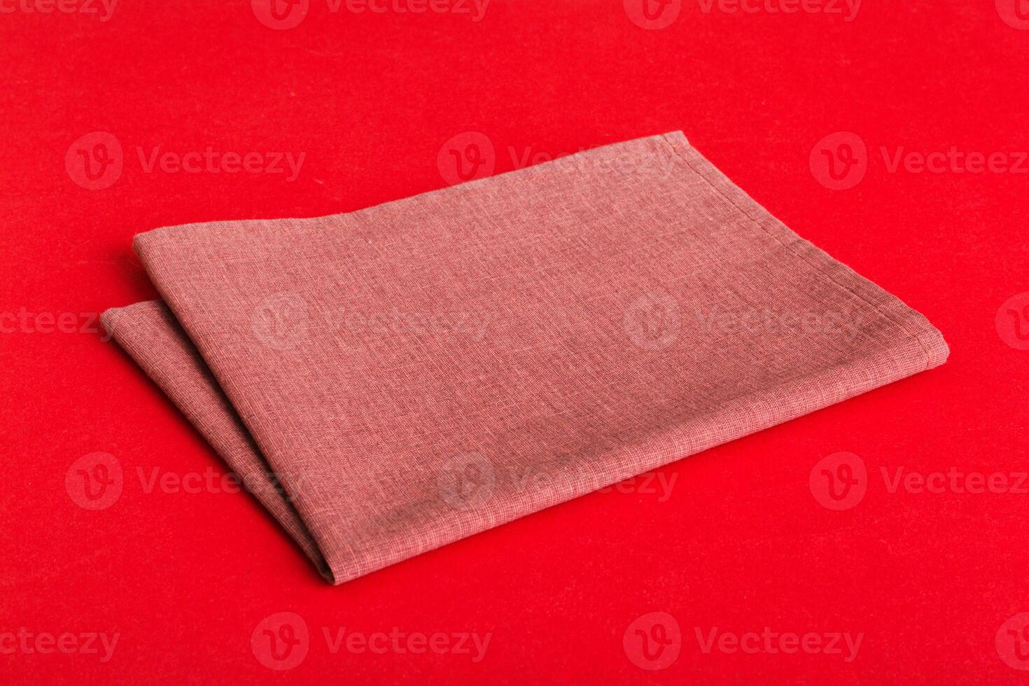 top view red empty kitchen napkin isolated on table background. Folded cloth for mockup with copy space. photo