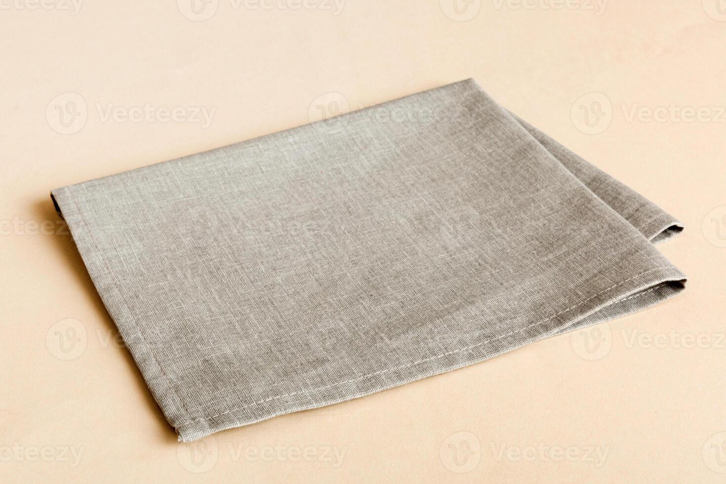 top view with gray kitchen napkin isolated on table background. Folded cloth for mockup photo
