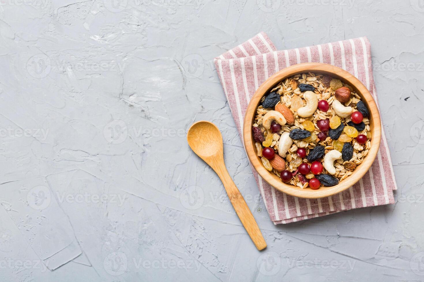 Cooking wholesome breakfast. Granola with Various dried fruits and nuts in a bowl. The concept of a healthy dessert. photo