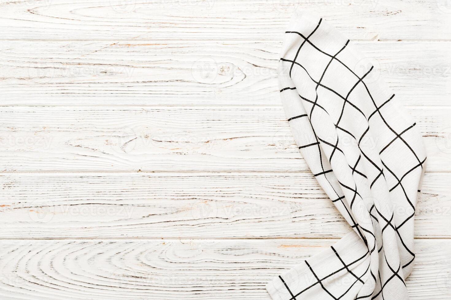 top view with empty kitchen napkin isolated on table background. Folded cloth for mockup with copy space, photo