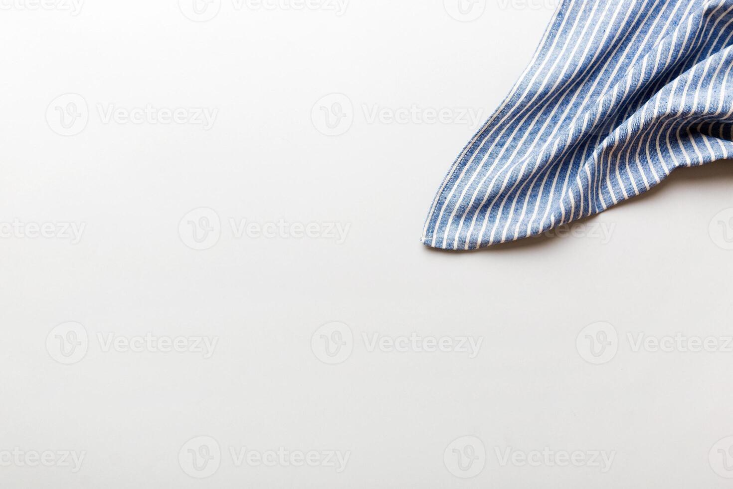 top view blue kitchen napkin isolated on table background. Folded cloth for mockup with copy space, photo