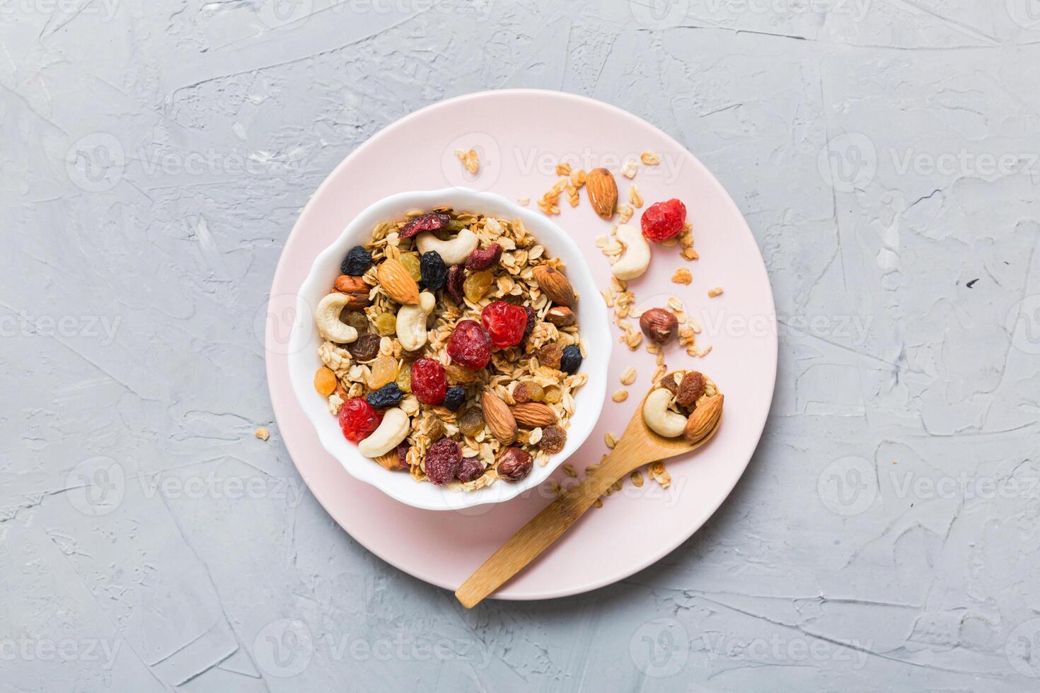 Cooking wholesome breakfast. Granola with Various dried fruits and nuts in a bowl. The concept of healthy dessert. top view with copy space photo