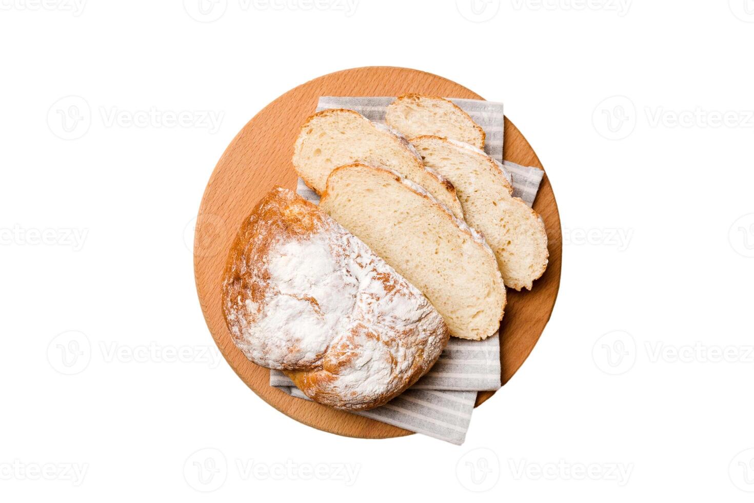 Freshly baked bread slices cutting board isolated on white background . top view photo