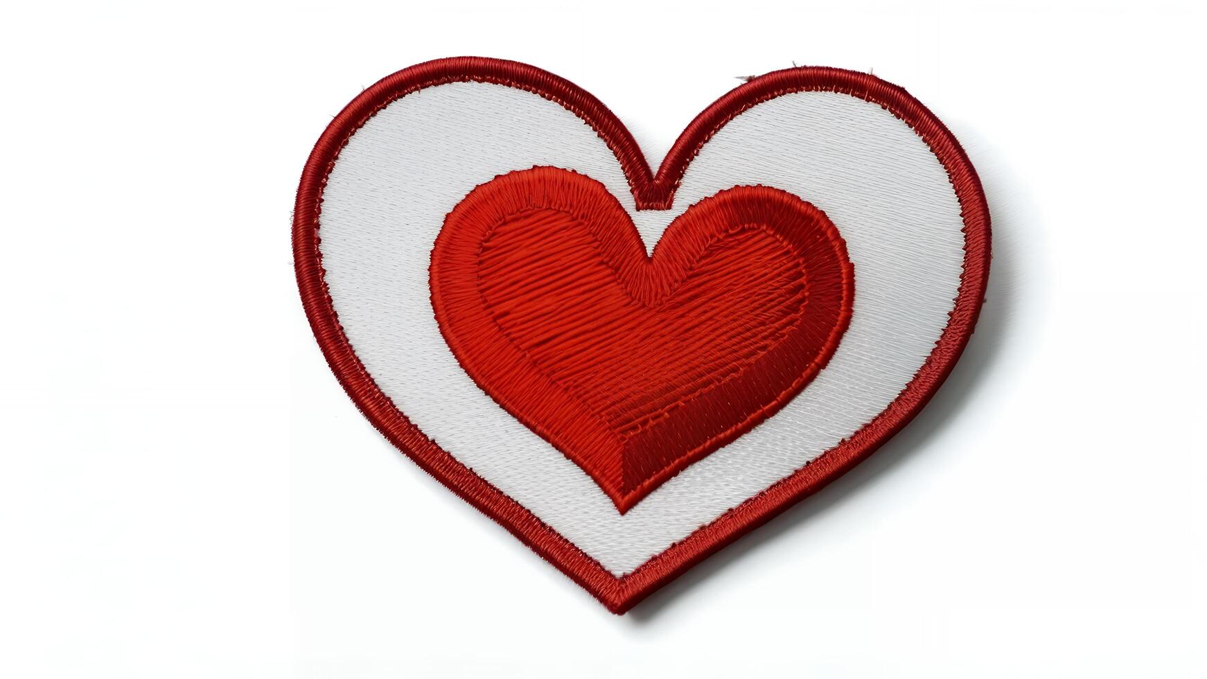 Red heart embroidered patch on white background. photo