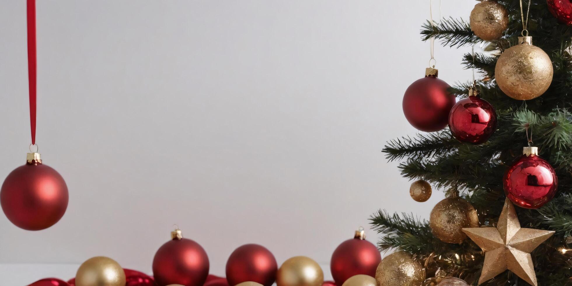 Red and gold Christmas ornaments hanging on a ribbon and decorating a Christmas tree against a white background. photo