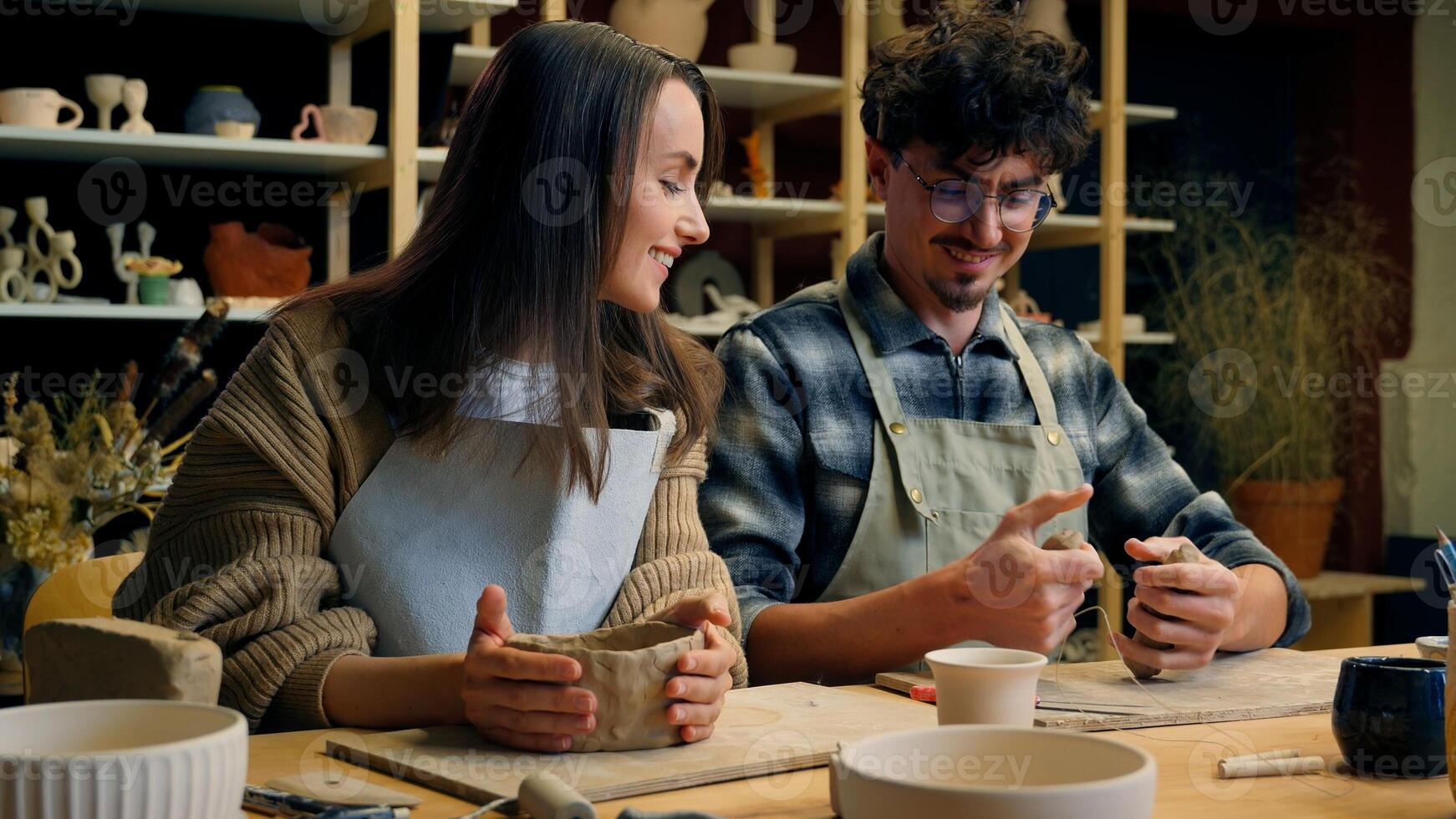 Happy woman man in pottery workshop creating handmade clay modeling class teacher student craft hobby sculpture couple date family potter artisan handcrafting ceramics have fun laughing in art studio photo