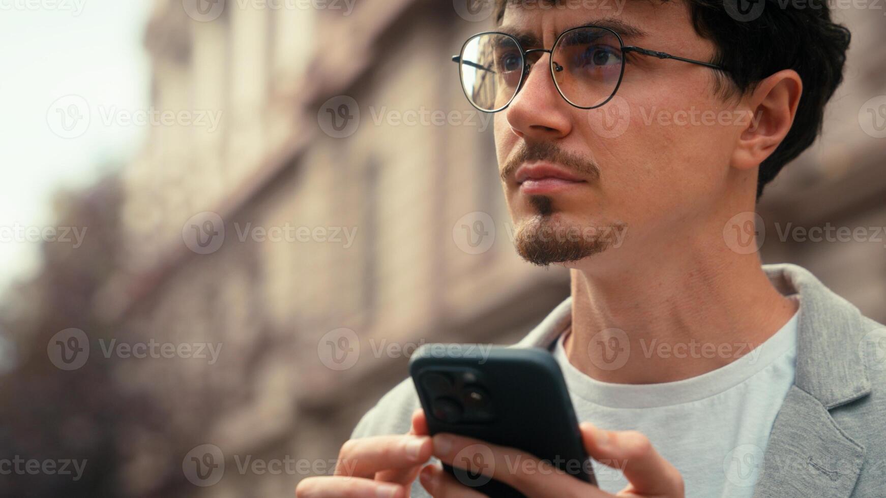 Pensive traveler tourist confused ethnic Hispanic man using mobile phone map navigation searching address navigator application online lost in city smartphone location looking around guy male outdoors photo