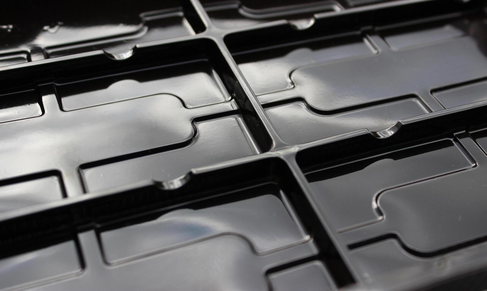 Abstract background of black figured extruded elements photo