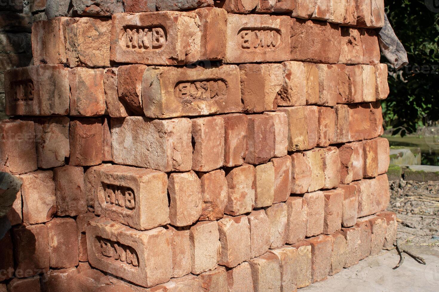 Many bricks are laid out at the construction site photo