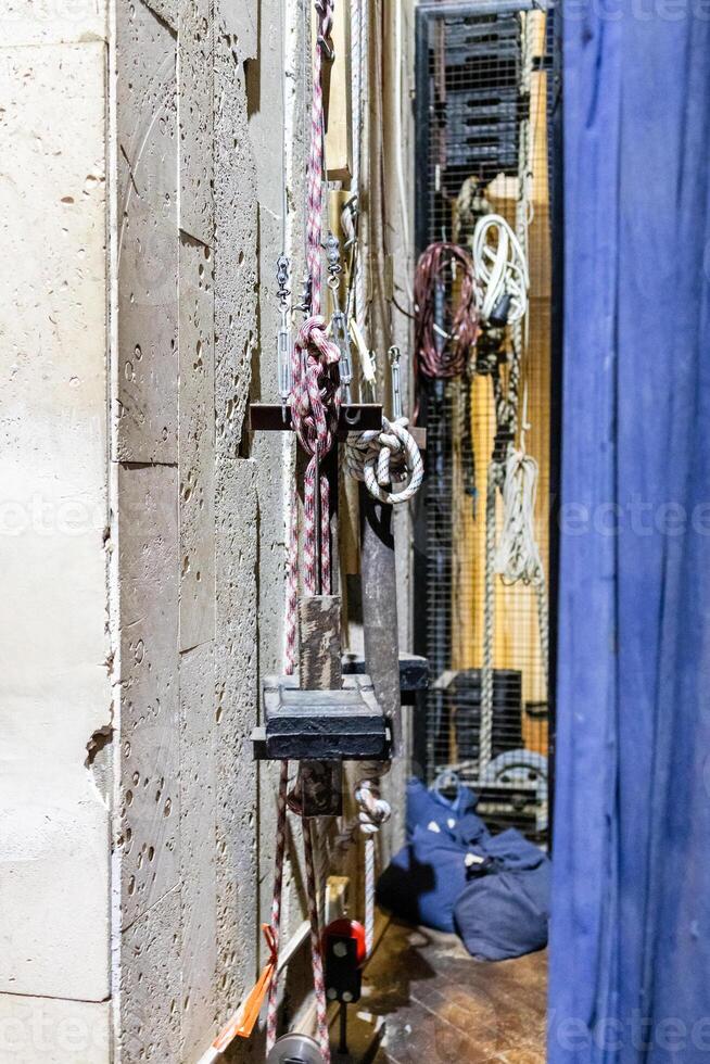 ropes and mechanisms for raising the curtain behind a theatre stage photo