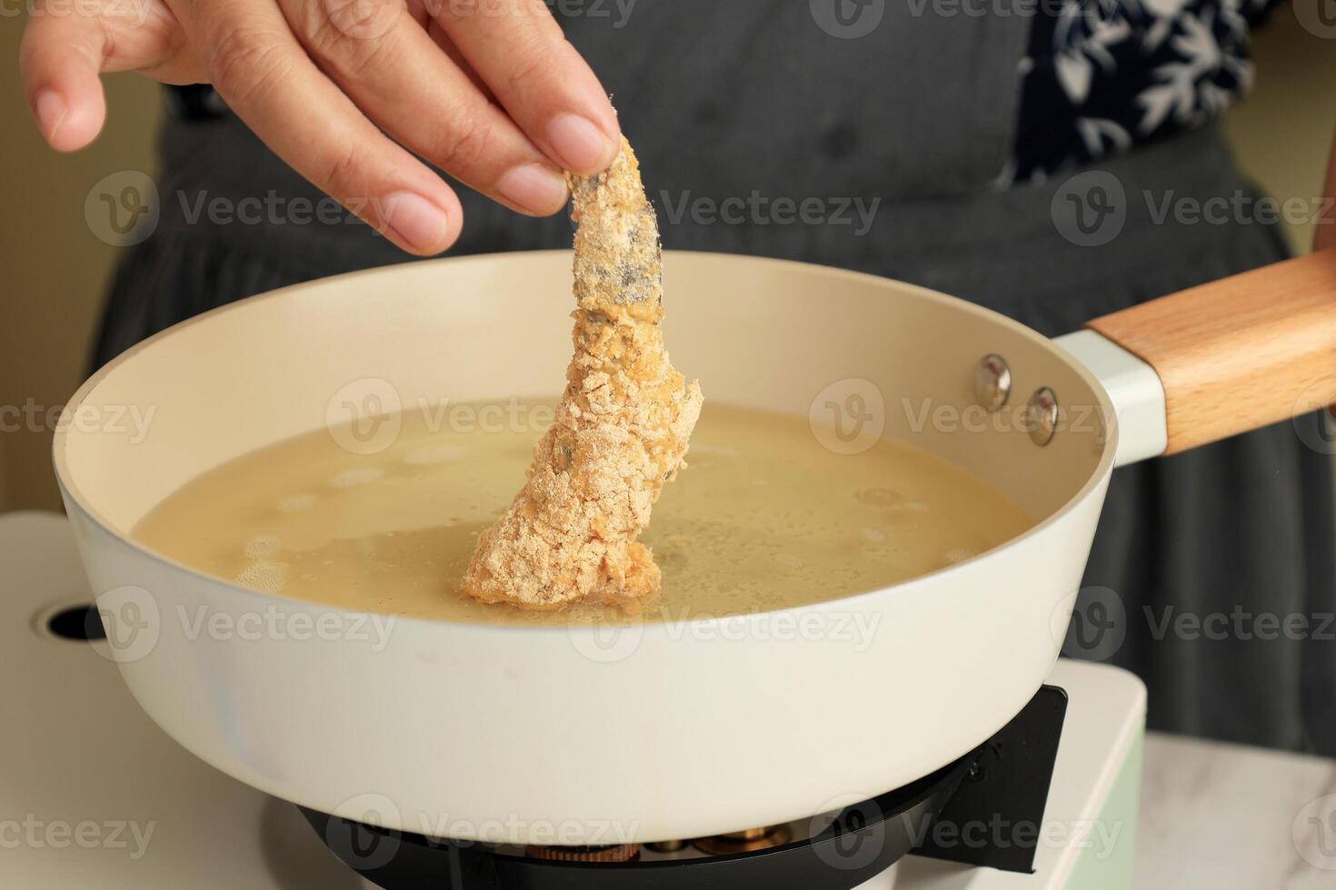 Chef frying prawns in oil photo