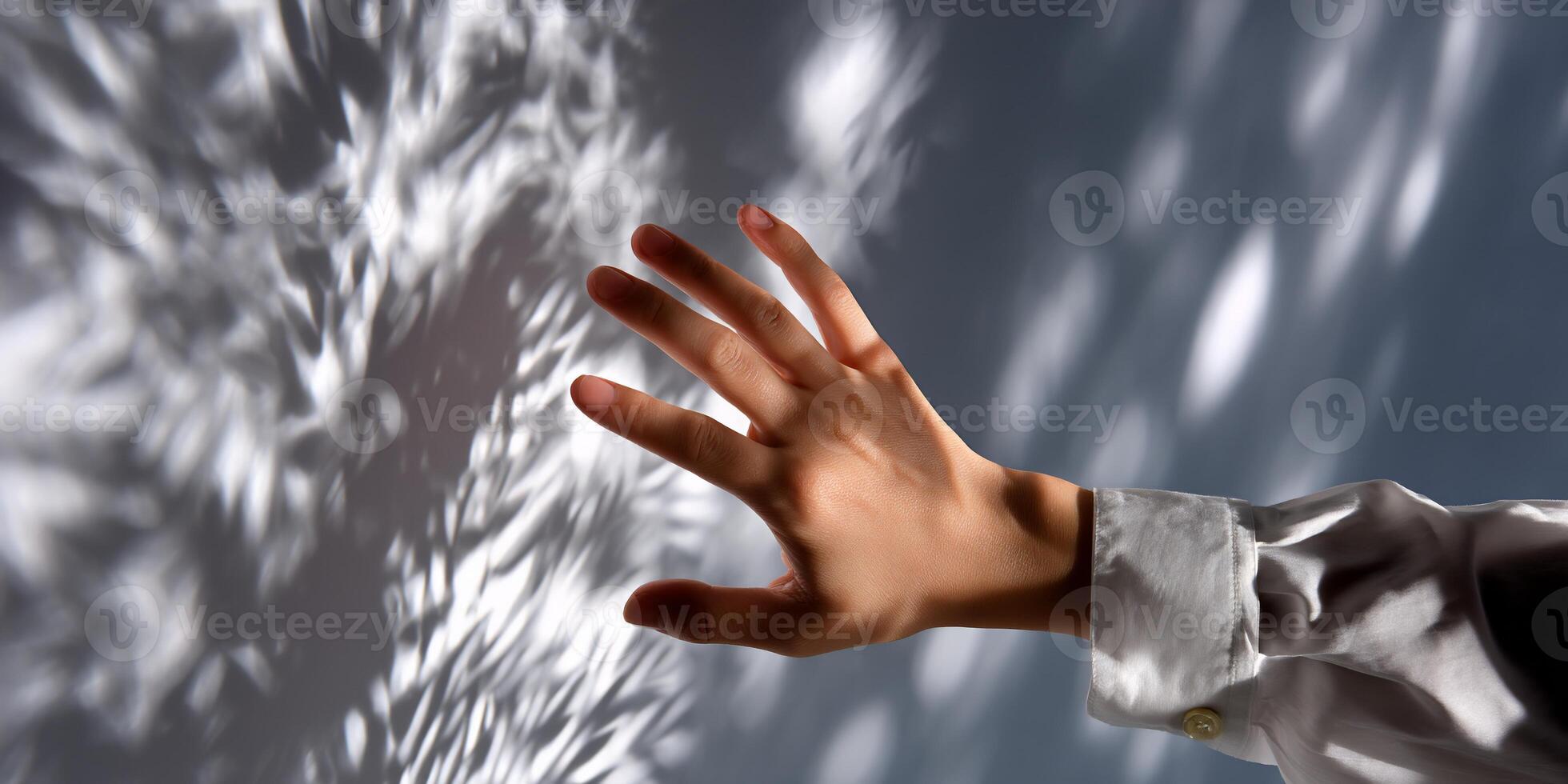 A hand reaching out to touch a wall photo
