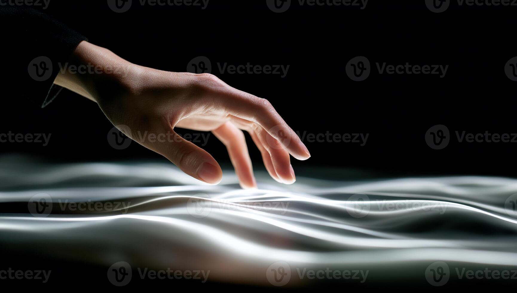 A person's hand touching a surface with a light source photo