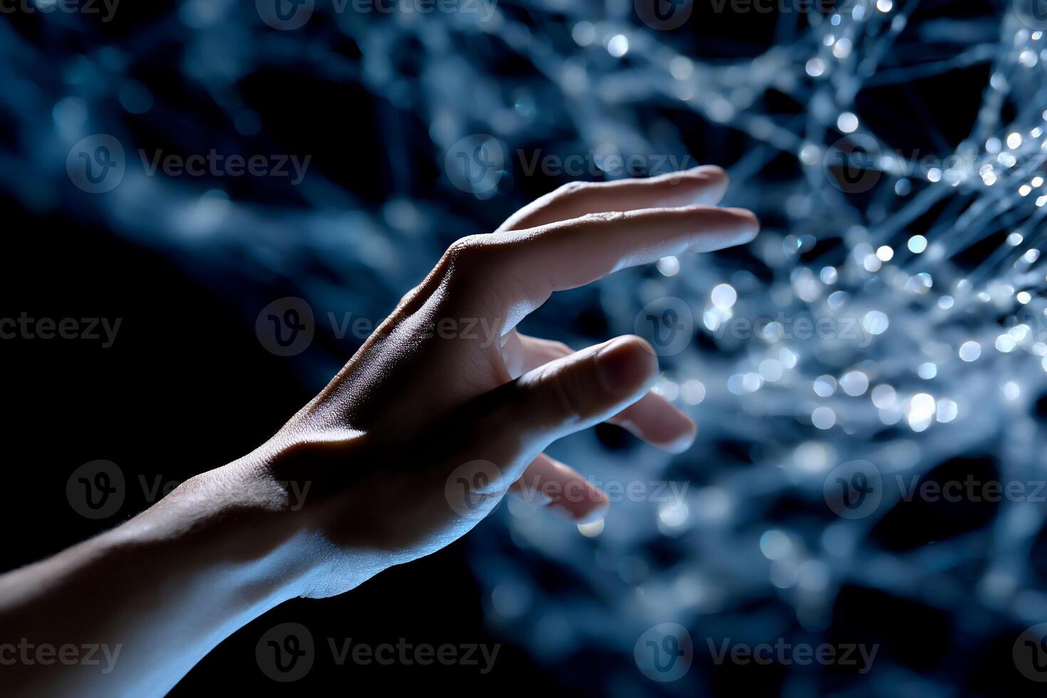 A hand reaching into a network of light photo