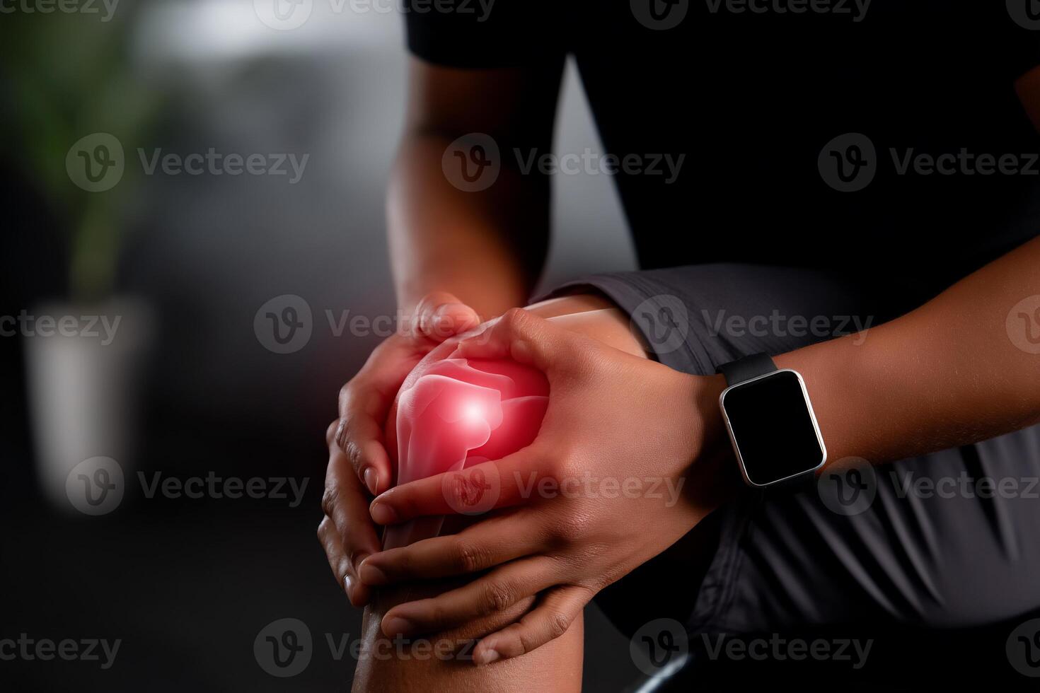A man with a knee pain holding his hand photo