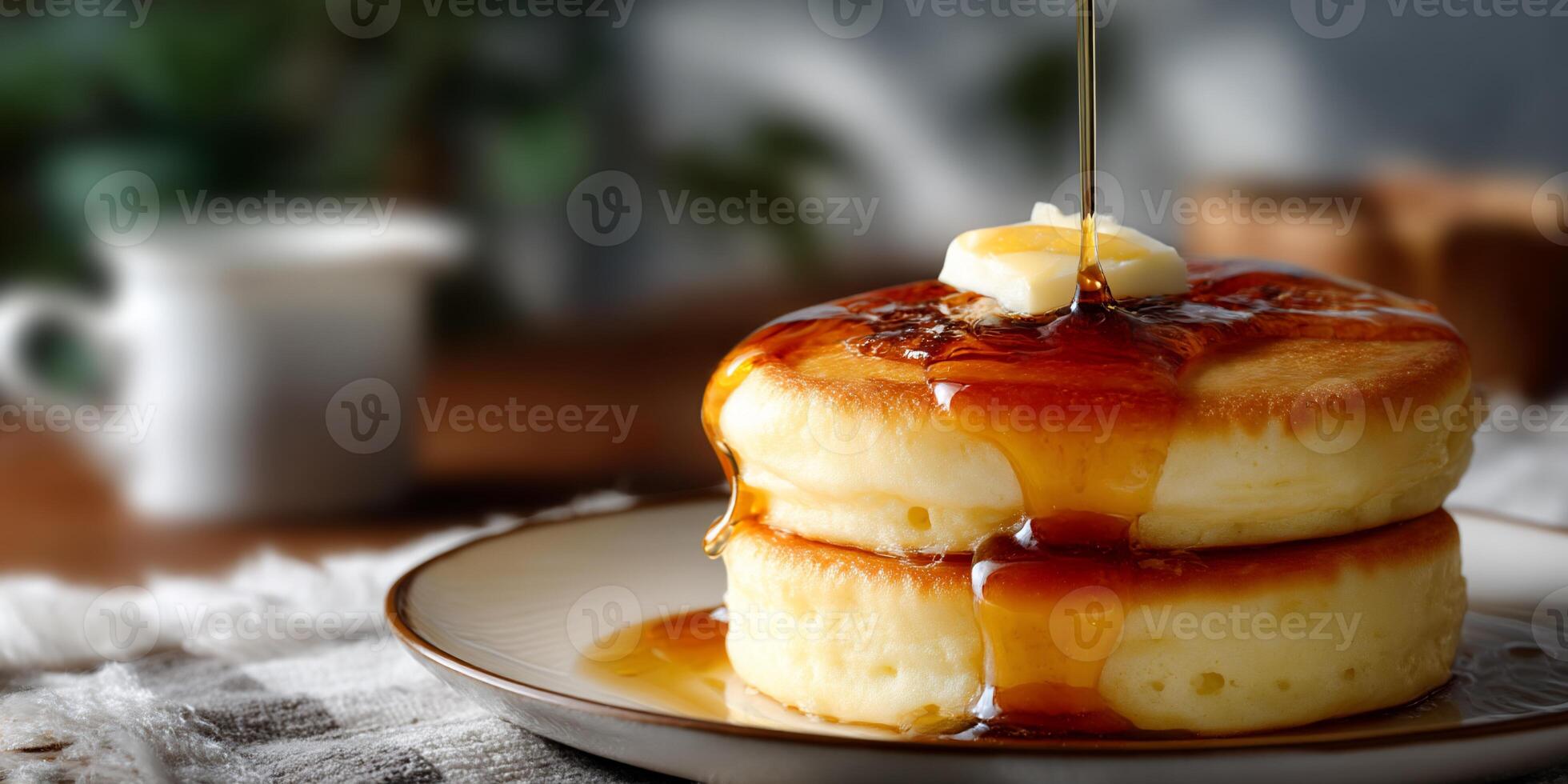 A stack of pancakes with syrup being poured on top photo