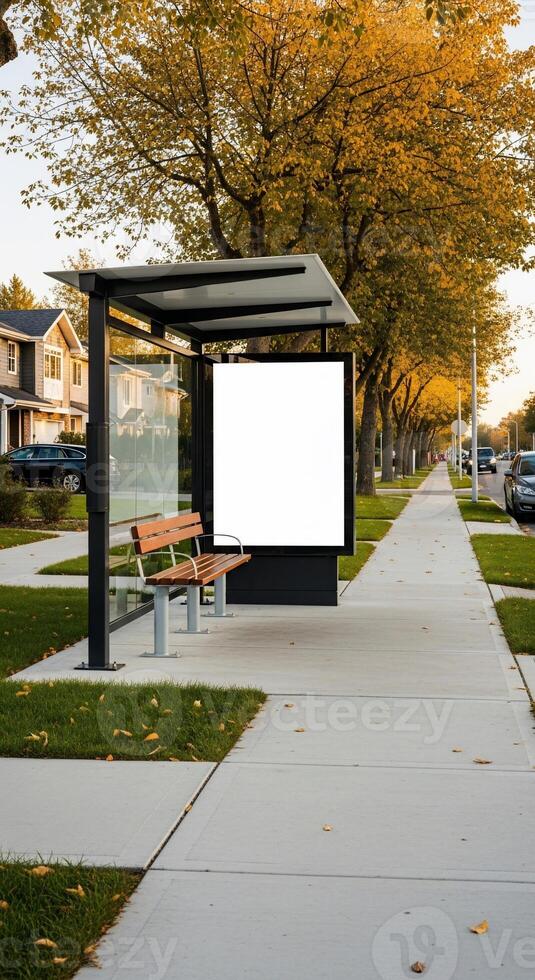 Autumnal Bus Stop with Blank Advertisement Board and Golden Foliage photo