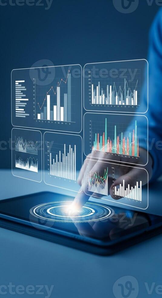 Businessman using tablet with business graphs and charts on screen photo