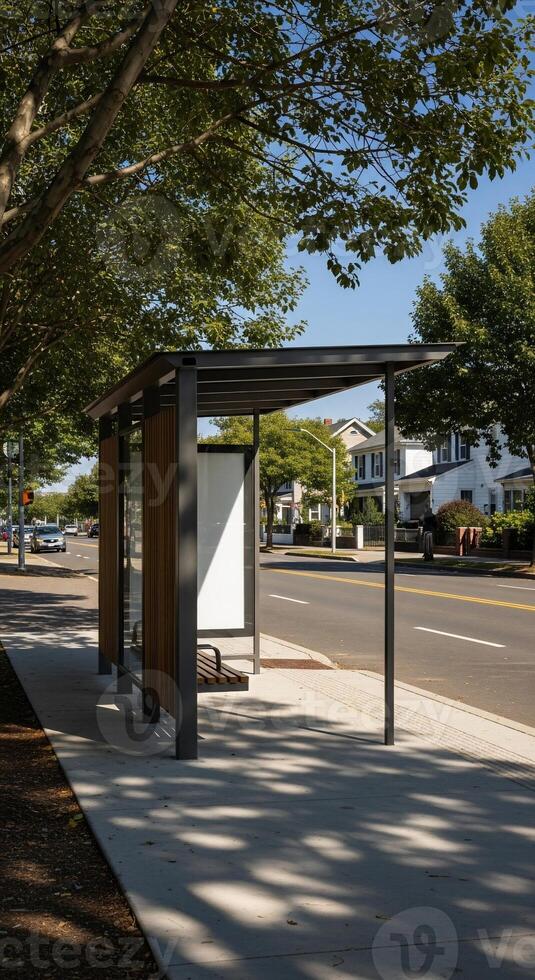 A bus stop with a bench and a tree photo