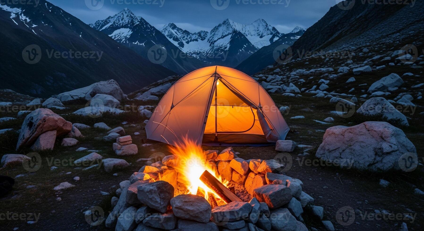 Illuminated Tent and Campfire in Mountainous Landscape photo