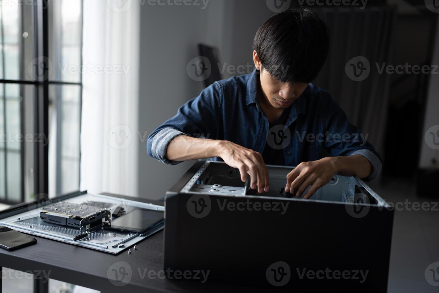 IT Engineer man is working on a computer with a laptop photo