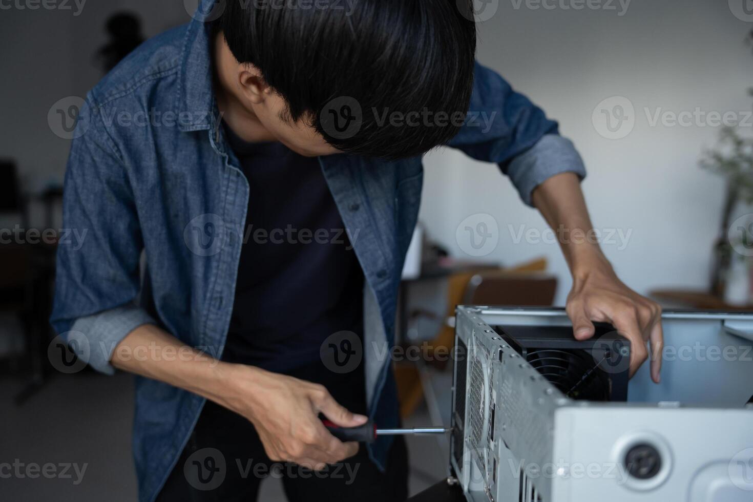 IT Engineer man is fixing a computer case photo