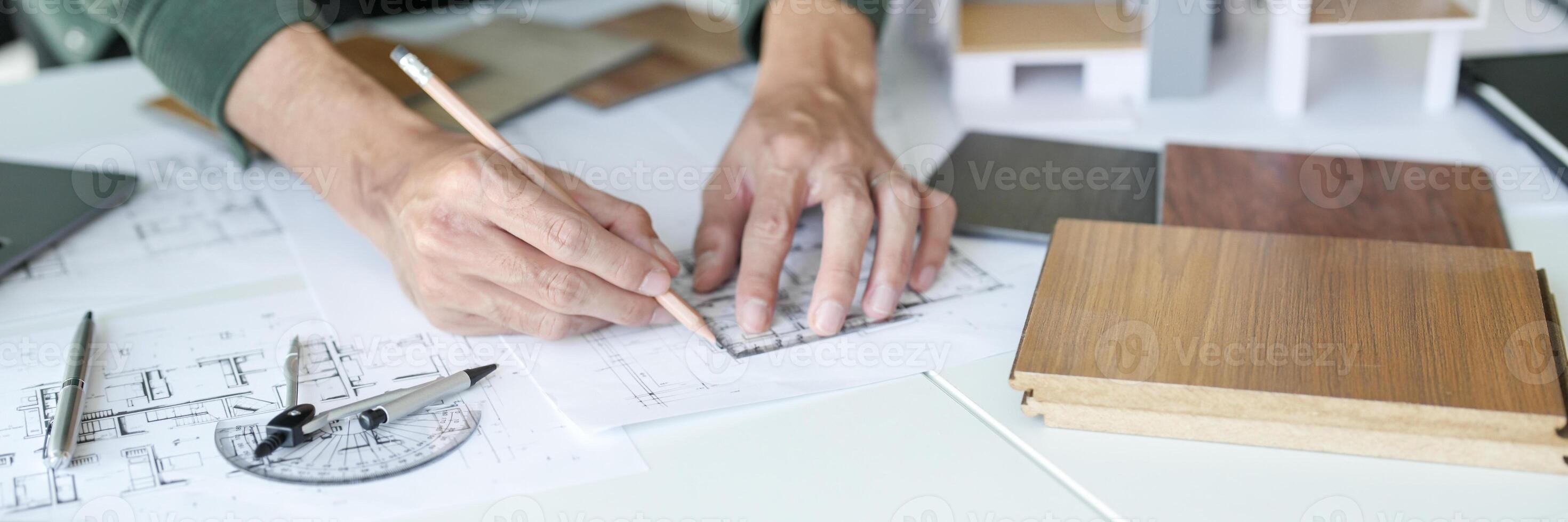 Architecture interior is working on a blueprint with a ruler and a pencil photo