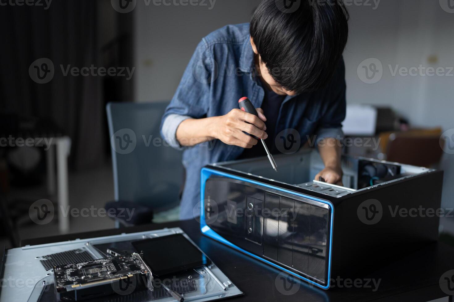 IT Engineer working on a computer in a room photo
