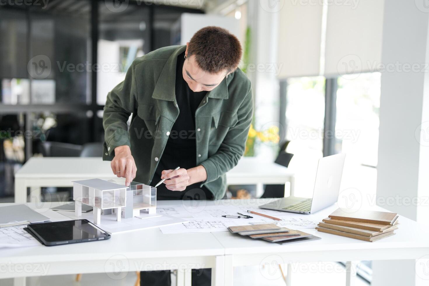Architecture interior is working on a model of a house photo