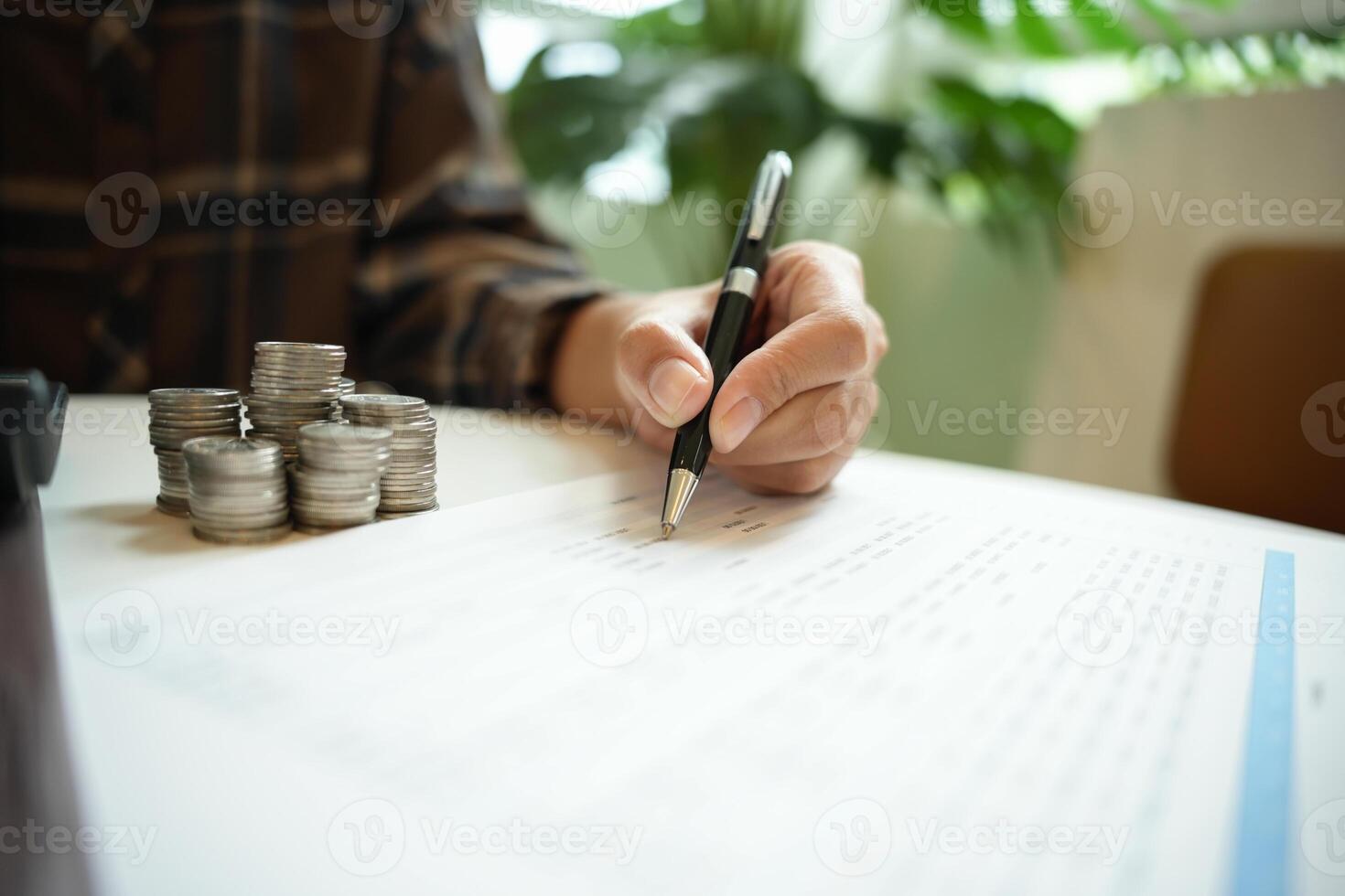 Businessman Accountant verify growing business saving money stacking coins with calculator. photo