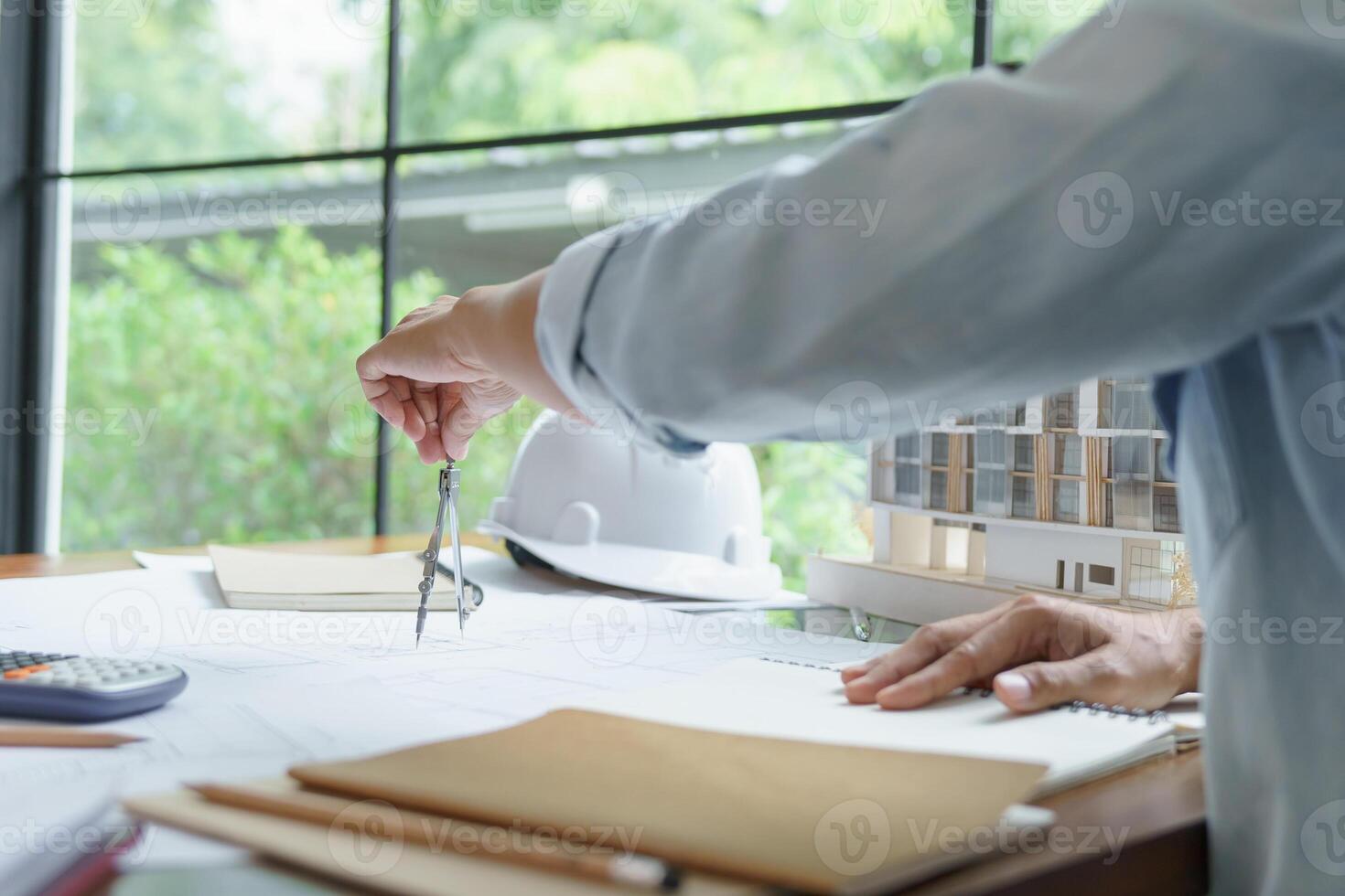 a engineer man is working on a project with a blueprint photo