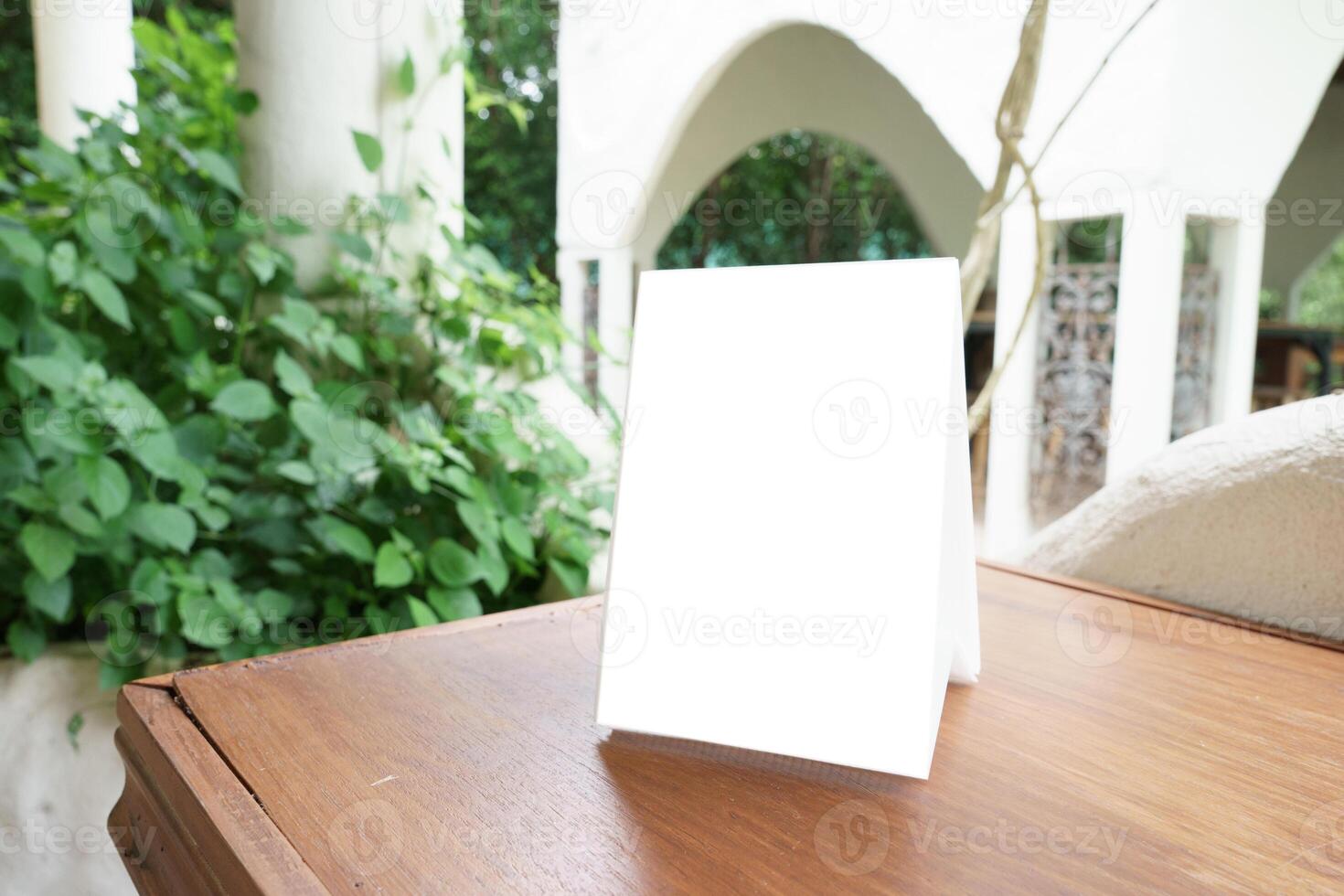 Menu mock up blank for text marketing promotion. Mock up Menu frame standing on wood table in restaurant for text. photo
