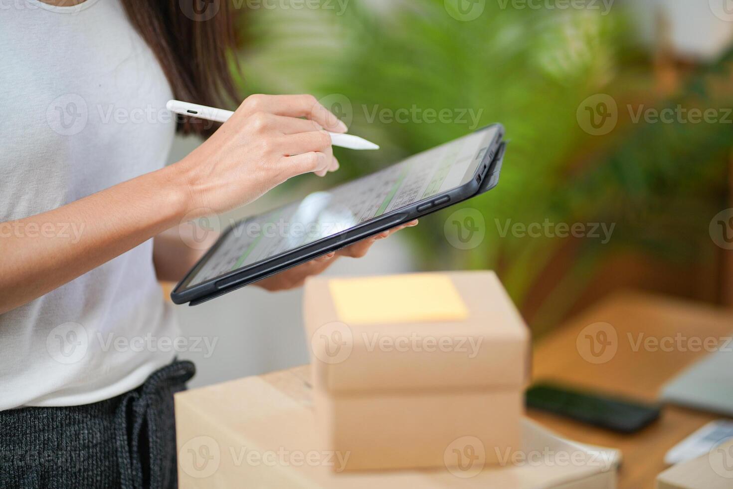 Business From Home, Asian woman preparing package delivery box Shipping for shopping online. young start up small business owner at home online order. photo