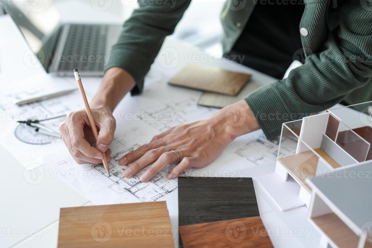 a person is working on a project with architectural plans photo