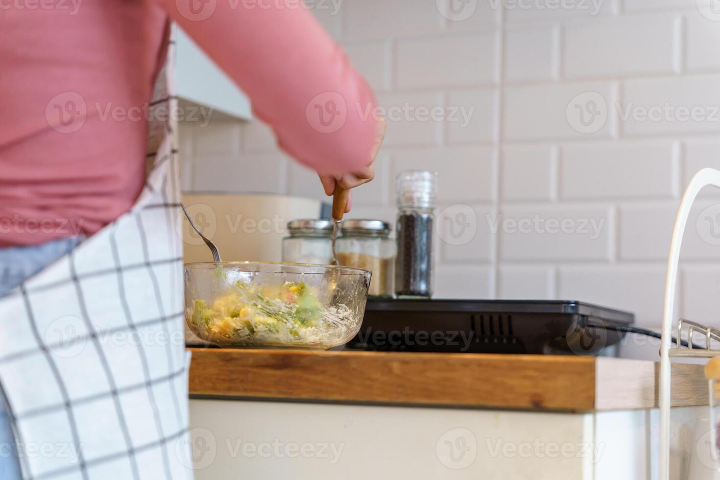 Asian woman preparing vegetable salad in the kitchen Healthy Food Healthy Cooking dieting Weight loss homemade salad healthy. photo