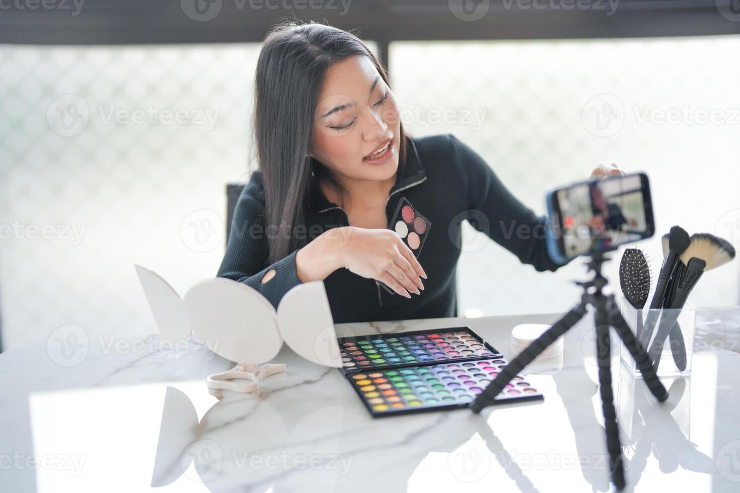 a woman is live streaming of her makeup photo
