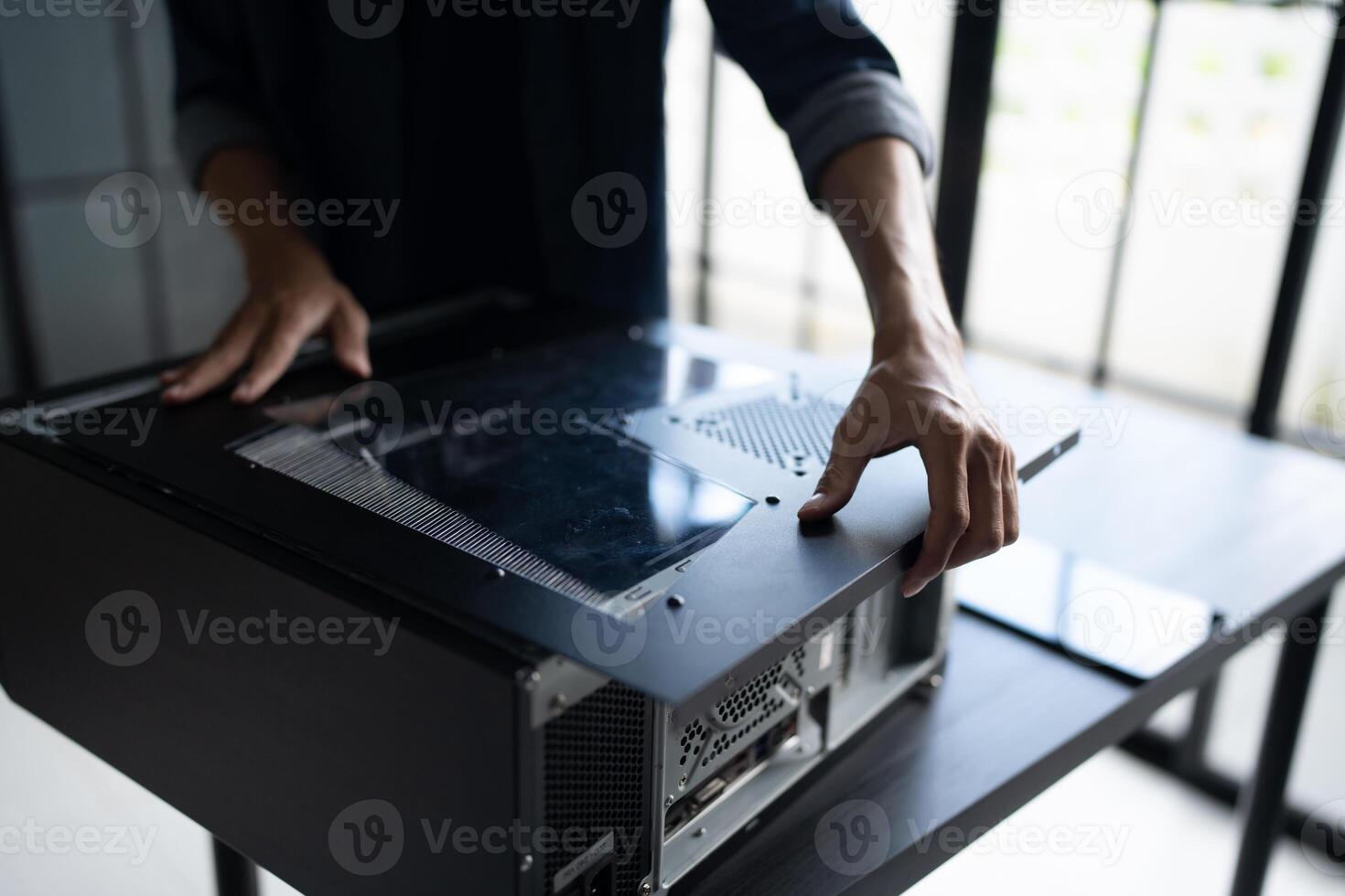 IT Engineer installing Hardware holding a computer case photo