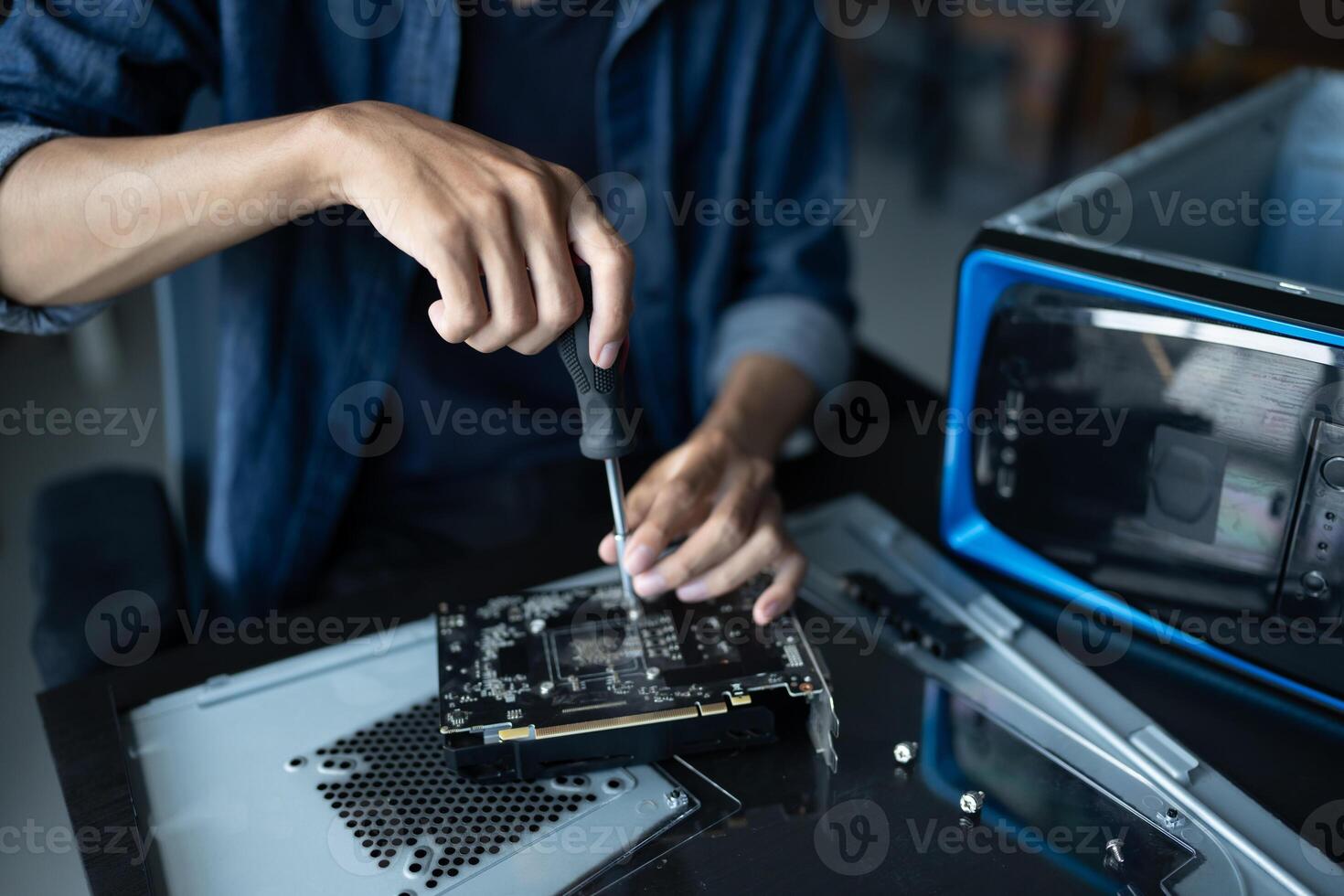 IT Engineer installing Hardware working on a computer with a screwdriver. photo