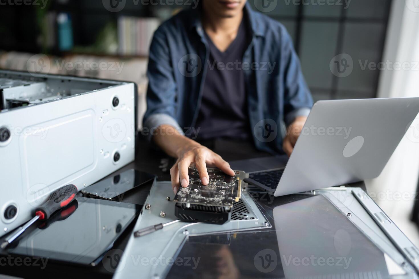 IT Engineer installing Hardware working on a laptop computer photo