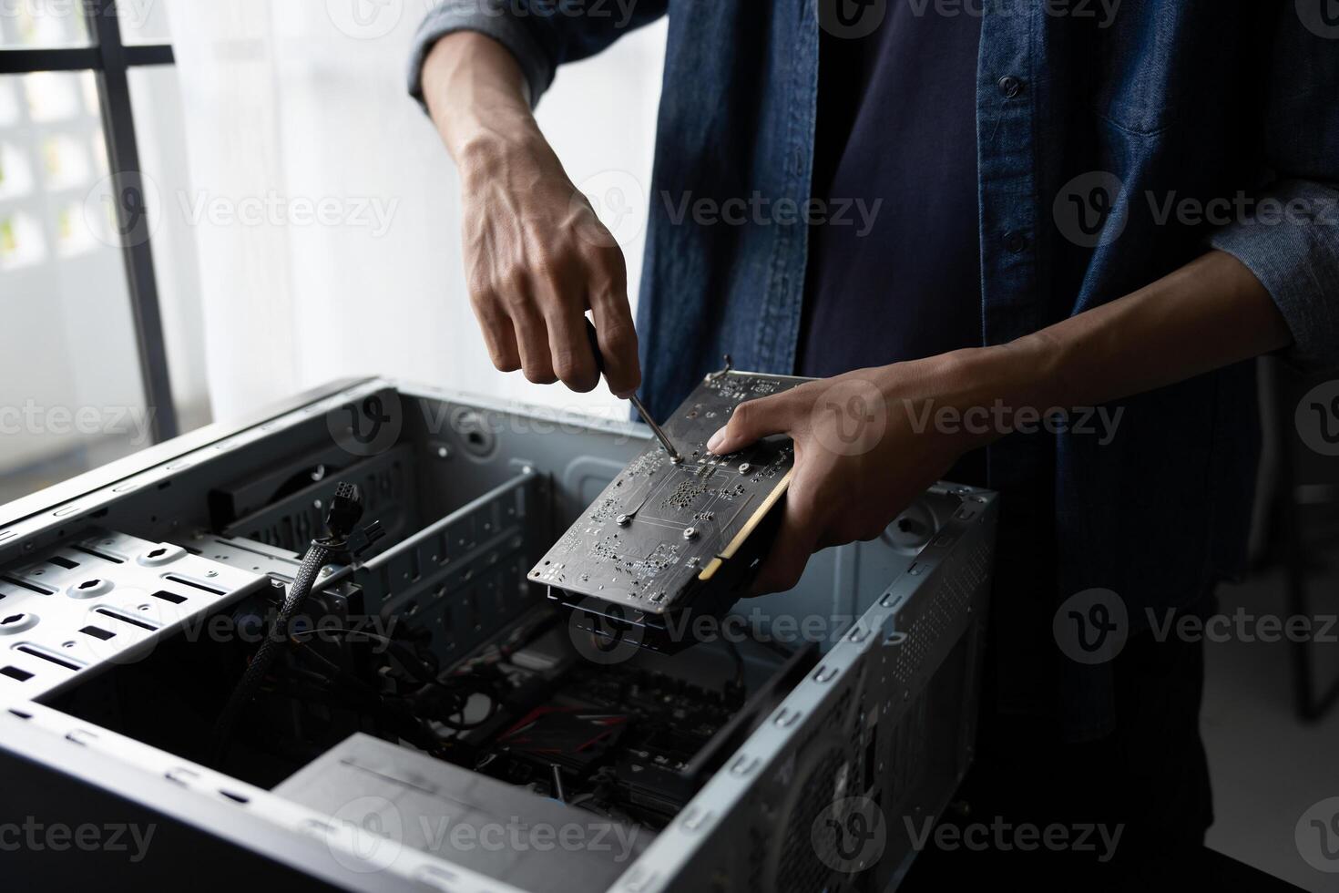a man is fixing a computer case. photo