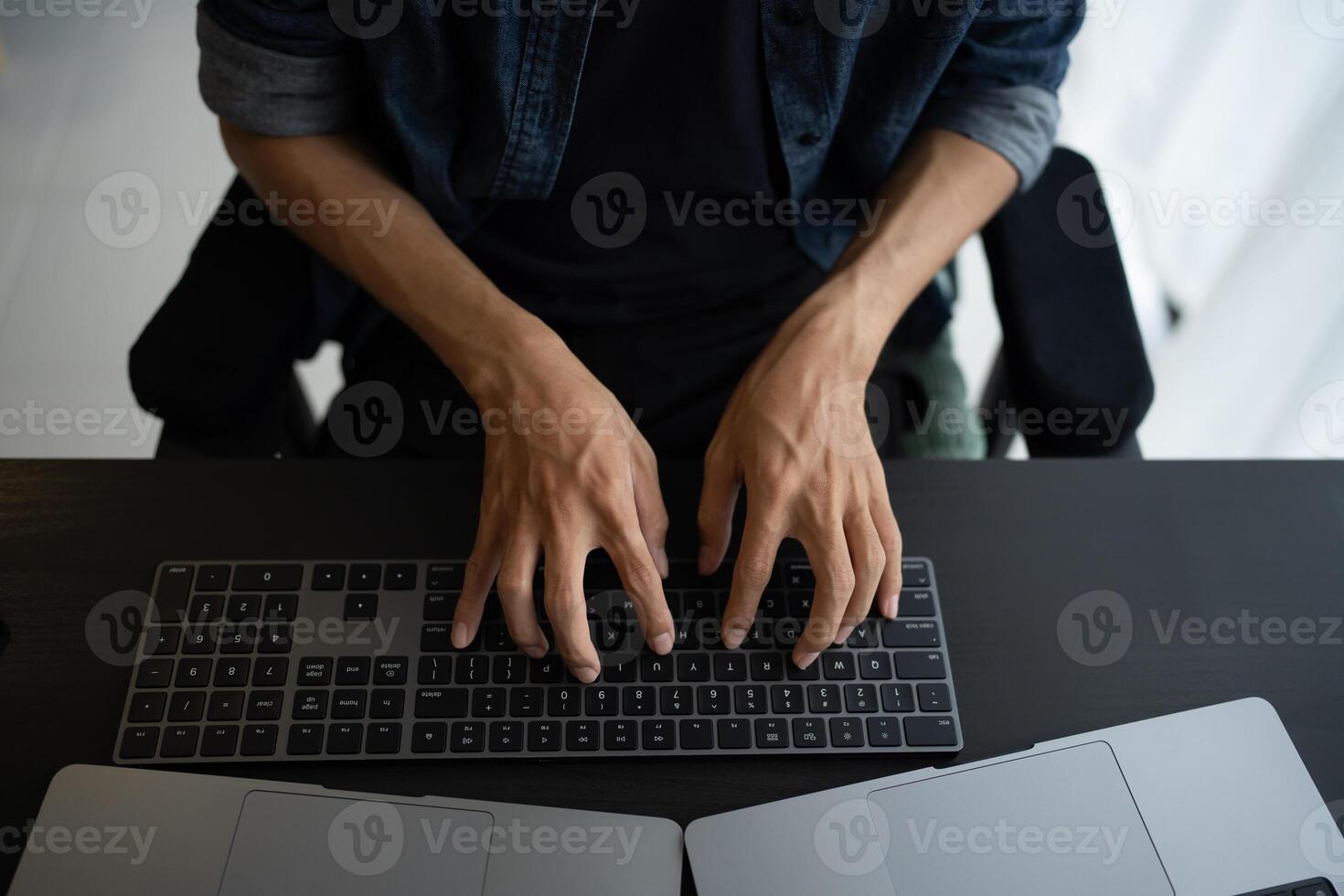 Asian man software engineer Working on Computer for writing program code IT Software Engineer finding errors devops creating digital photo