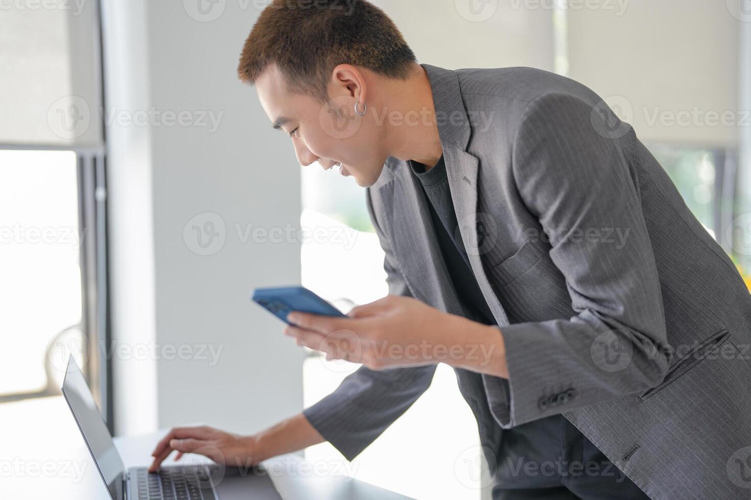 a man in a suit holding a cell phone photo